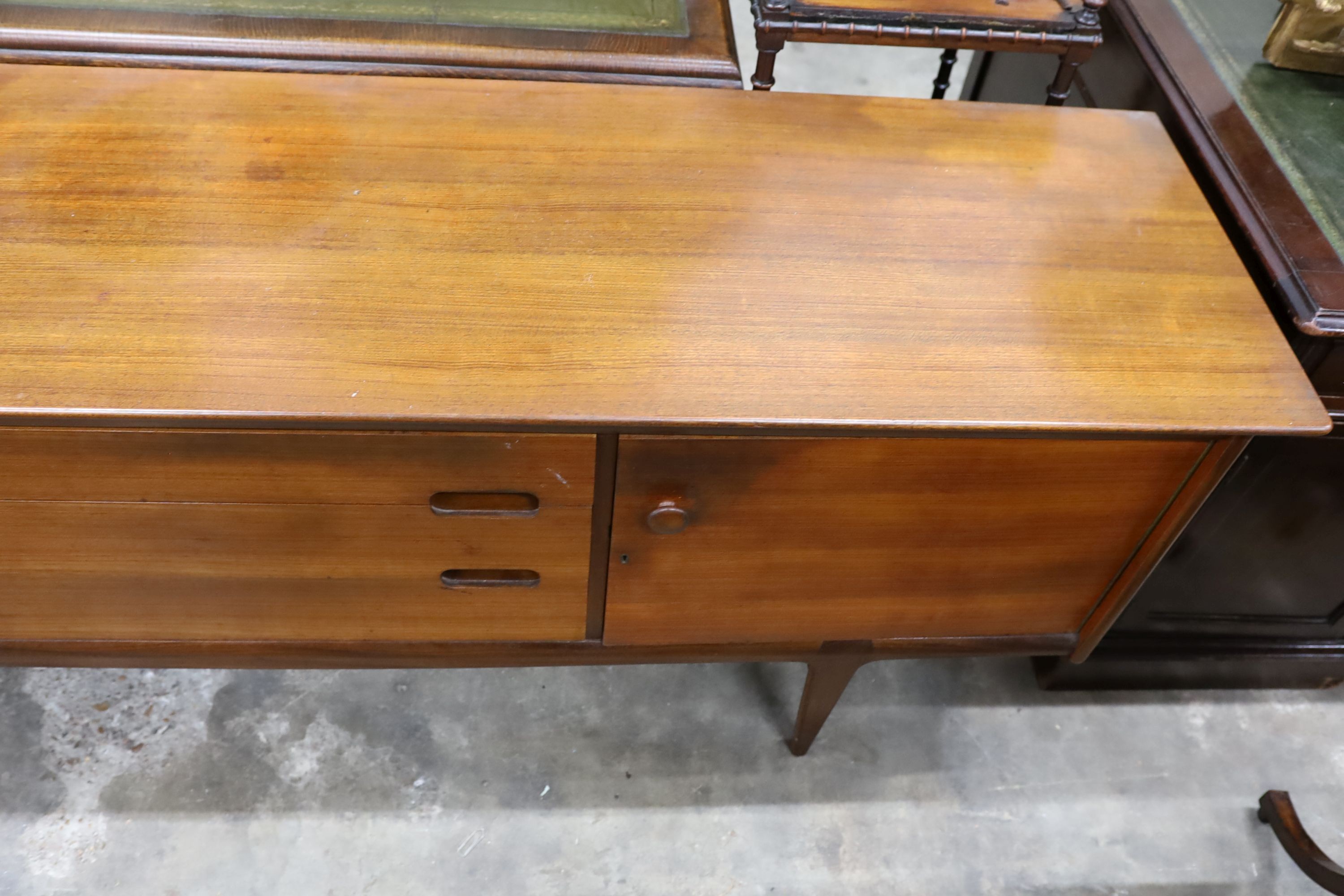 A mid century design teak sideboard, length 209cm, depth 49cm, height 75cm